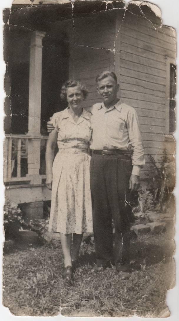 Scratched and faded old family photo before restoration