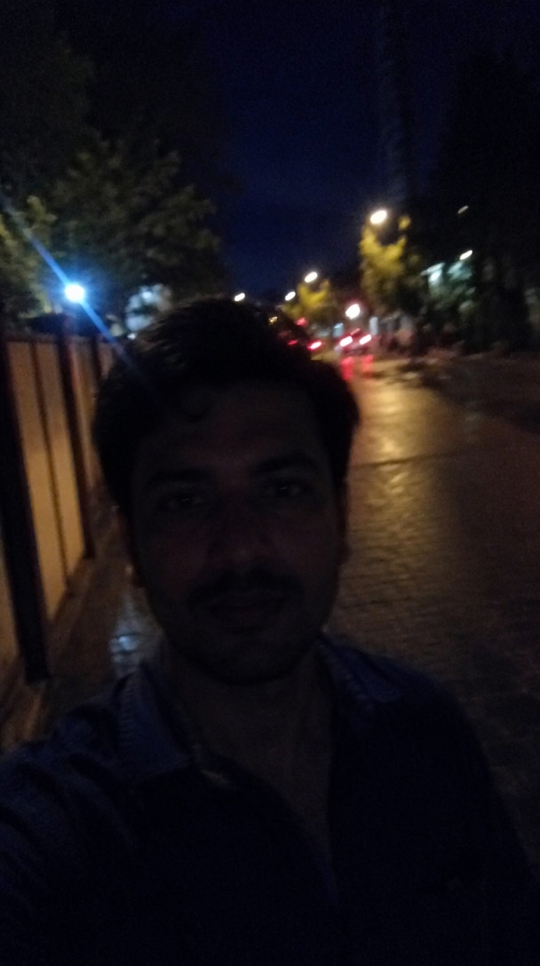 Dark noisy night selfie before AI enhancement