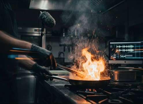 Short flare-up whoosh timed to a pan igniting on a stove