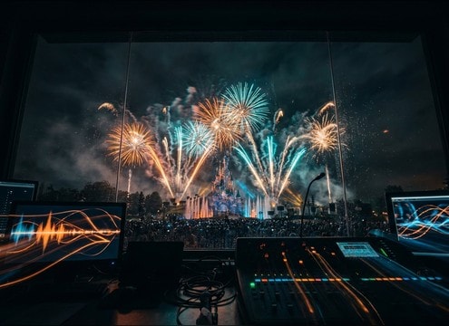 Theme park fireworks cue aligned to music beats