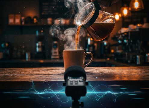 Coffee being poured from a carafe into a ceramic mug