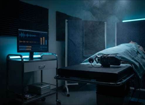 Film editor adding realistic stomach sounds to a clinic scene
