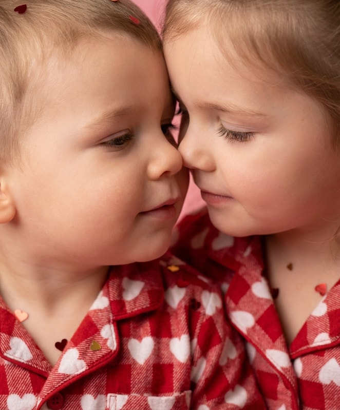 toddler sibling cheek to cheek