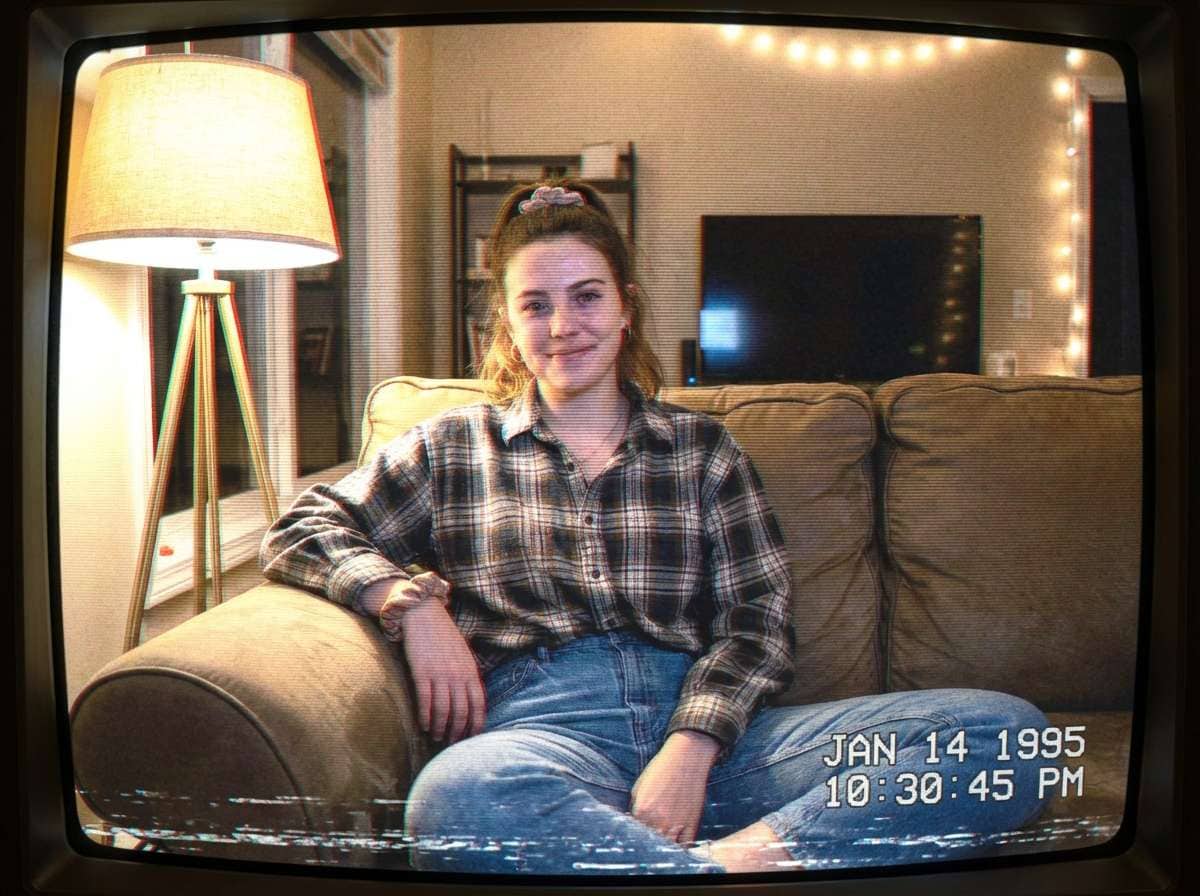 after - same woman in bedroom with AI-applied VHS filter, tracking lines, color bleed, retro date stamp, camcorder aesthetic